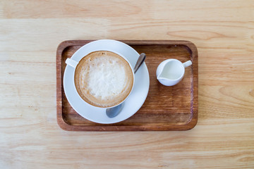 Wall Mural - coffee cup and milk on wood table