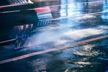 Wall Mural - Cars driving on wet road in the rain with headlights