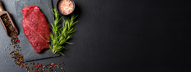 Raw beef steak with herbs and spices. Close up