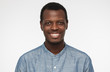 © Damir Khabirov - Close up portrait of smiling handsome african american man entrepreneur in blue shirt isolated on gray background