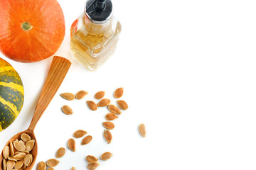 Wall Mural - Fresh pumpkin oil isolated on white background. Flat lay, top view. Free space for text.