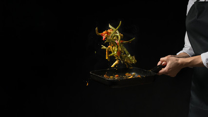 The chef prepares. Black background for copy text.Concept cooking