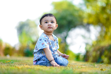 Wall Mural - cute indian baby boy playing at garden