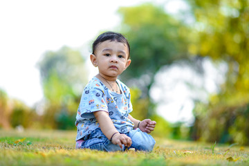 Wall Mural - cute indian baby boy playing at garden