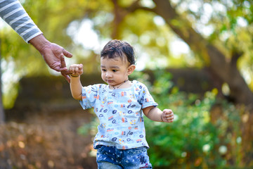 Wall Mural - cute indian baby boy playing at garden