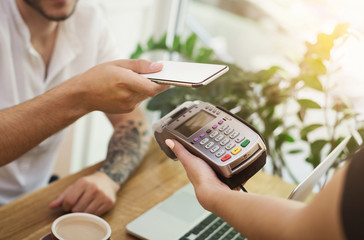 Man paying bill through smartphone using NFC technology