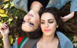 © dobok - two girlfriend portrait, lying on the ground in a park in autumn