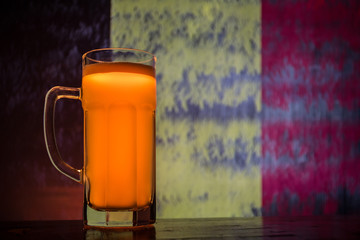 Wall Mural - Soccer 2018. Single beer glass on table at dark toned foggy background. Support Belgium with beer concept.