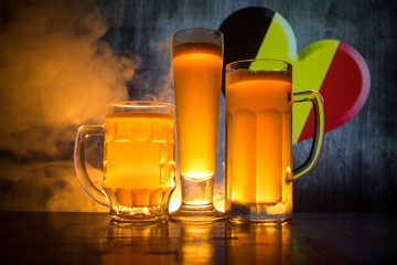 Wall Mural - Soccer 2018. Beer glasses on table at dark toned foggy background. Support Belgium with beer concept.