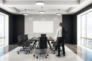 Wall Mural - businessman looking at blank poster