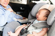 © van_sinsy - Asian little smiling baby child fastened with security belt in safety car seat