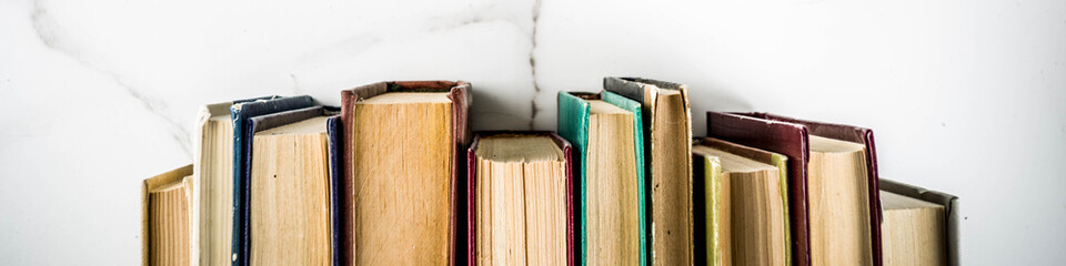 Back to school background with old books, alarm clock, pencils banner