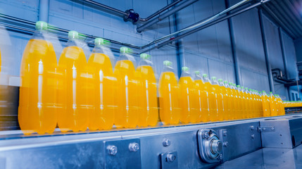 Beverage factory interior. Conveyor with bottles for juice or water. Equipments