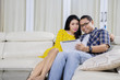 © Creativa Images - Asian couple using tablet together at home