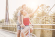 Happy millennial couple taking photo selfie with smartphone on bicycle