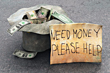 Beggar's Hat With Money On The Street
