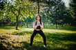 © Вероника Преображенс - A beautiful girl in the park is engaged in sports. The model clasped two hands. Makes exercise in nature.