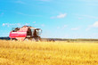 © Lazy_Bear - Combine harvester agriculture machine harvesting ripe wheat in farm field