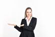 © S photographer - Business Concept. Beautiful businesswoman poses confidently. Young businesswoman pointing on copy space. Beautiful young businesswoman is presenting a job.