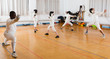 © JackF - adults and children athletes at fencing workout