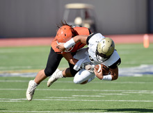 Football Player Making A Tackle During A Game