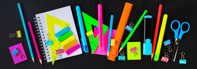 Wall Mural - School supplies on blackboard background ready for your design. Flat lay. Top view.