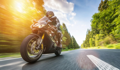 motorbike on the road riding. having fun riding the empty road on a motorcycle tour / journey