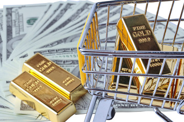 Gold bars in shopping  trolley with yellow mark for supermarket and 2 gold bars on bank note.