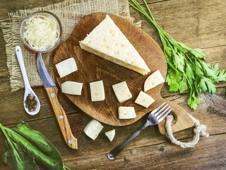 sliced cheese on a wooden board