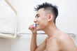© i am way - Man brush teeth in bathroom morning day
