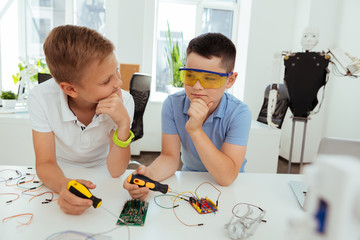 Wall Mural - new solutions. smart nice boys thinking while looking for new ideas