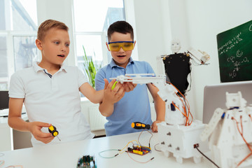 Wall Mural - school lessons. smart young boys standing in the classroom while working together on the project