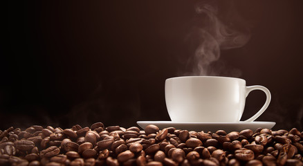 Cup of hot coffee with smoke on coffee beans