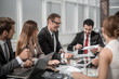 © ASDF - business team discussing financial issues at a working meeting