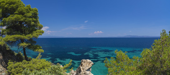 Beautiful panorama with the Mediterranean sea in Greece. crystal and colorful water, rocks, vegetation, beac