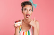 Beautiful pin up woman isolated holding cake.