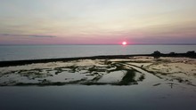 A Stunning Drone Flyby Of A Paddle-boarder At Sunset On A Scenic Salt Water Marsh. Shot In Falmouth, Cape Cod.