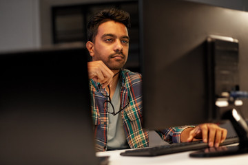 deadline, technology and people concept - close up of creative man with glasses working at night off