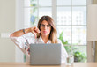 © Krakenimages.com - Young woman at home using laptop with angry face, negative sign showing dislike with thumbs down, rejection concept