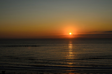  Beach of Black Sea from Mamaia, Romania with golden orange sky, sands and blue clear water, sunrise
