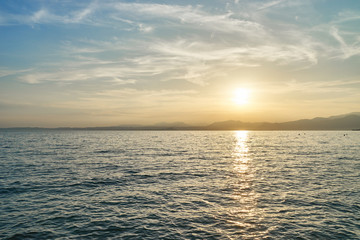 Wall Mural - Spectacular sunset with beautiful light at City of Bardolino / Lake Garda in Italy