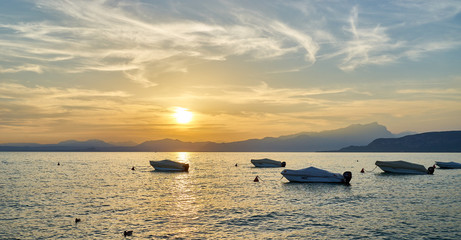 Wall Mural - Spectacular sunset with beautiful light at City of Bardolino / Lake Garda in Italy