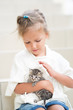 © Evgenia Tiplyashina - little girl plays for four years with a kitten