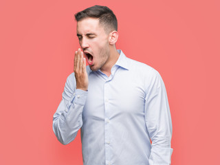 Poster - Handsome young businessman bored yawning tired covering mouth with hand. Restless and sleepiness.