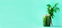 Banner Of Green Smoothie With Leafy Beet Greens And Carrot Tops On Blue Background, Copy Space. Summer Vegan Food Concept. Healthy Detox Diet. Fresh Squeezed Juice, Drink From Vegetables.