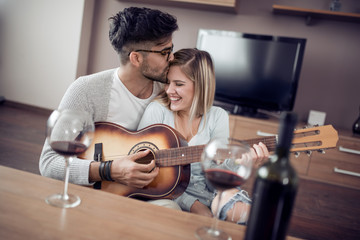 Poster - Young couple enjoying wine at home