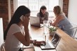 © Wavebreak Media - Businesswomen using laptop while sitting in office