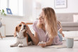 © New Africa - Young woman with her dog at home