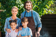 © LIGHTFIELD STUDIOS - portrait of smiling family looking at camera on backyard on summer day