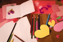 Heart Shape Craft And Colored Pencil On Wooden Floor